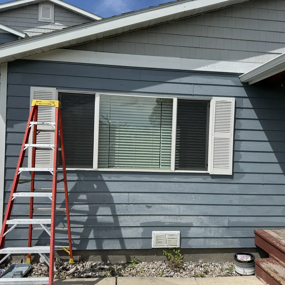 Residential Painting in Bozeman - MT in progress as a painter rolls color onto a living room wall