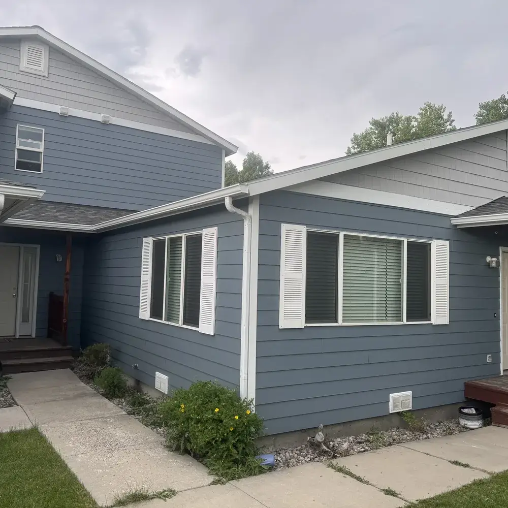 Residential Painting in Bozeman - MT in progress as a painter rolls color onto a living room wall